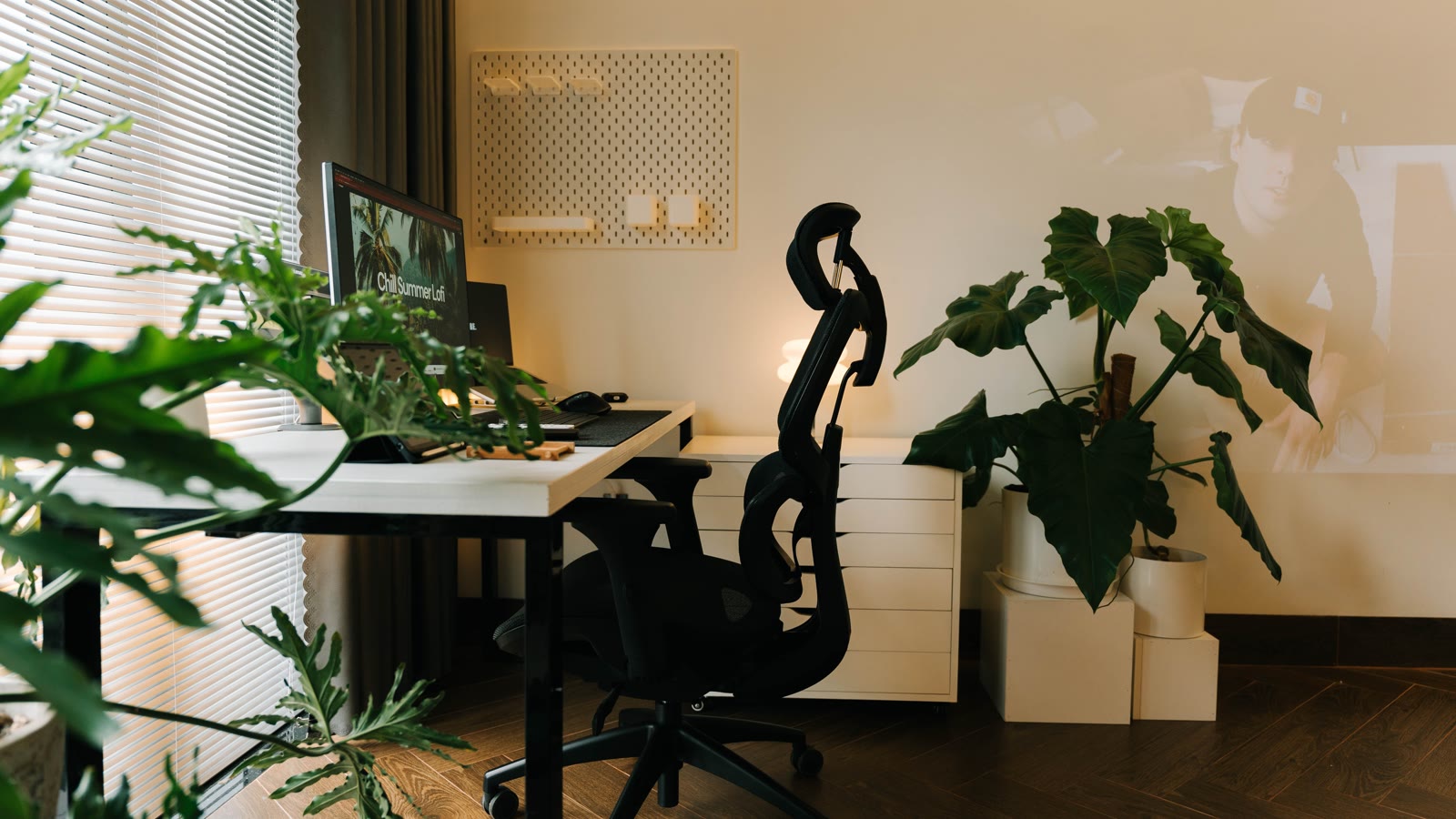 Lille hjemmekontor med skrivebord, kontorstol og grønne planter